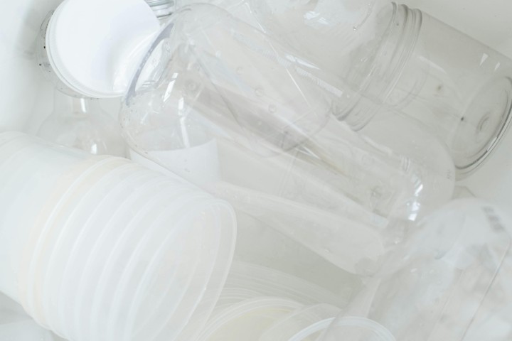 Clear Plastic Bottles in White Ceramic Sink